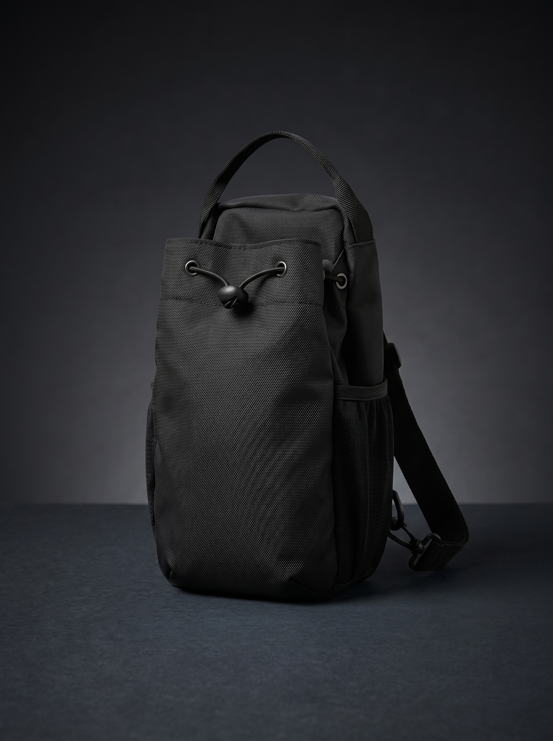 The Stash — dark studio, drawstring closure and shoulder strap